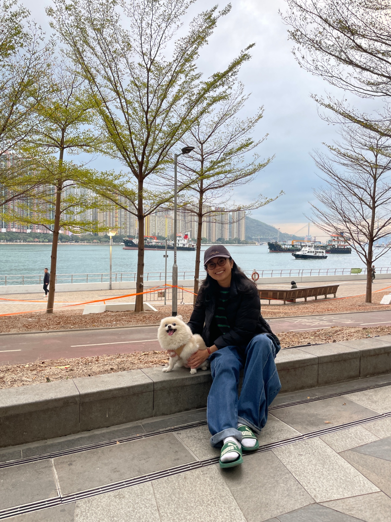Irish Isip on the Hong Kong waterfront with her dog